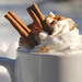 Hot cocoa with whipped cream and cinnamon sticks