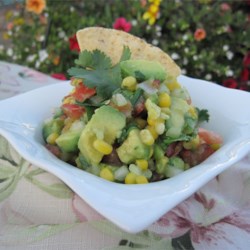 Best Ever Cilantro Corn Salsa Recipe - Grilled fresh sweet corn combines with chopped tomatoes, avocado, and cilantro in a light vinaigrette dressing.