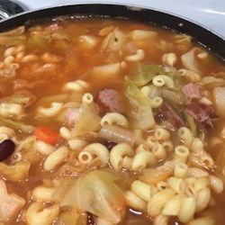 Portuguese Bean Soup II Recipe - Portuguese sausage is slowly cooked with potatoes, cabbage, kidney beans, ham and pasta in this rich, hearty soup.