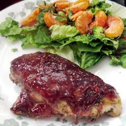 Raspberry-Glazed Rosemary Chicken Recipe - Easy yet gourmet in appearance, chicken breasts are baked with a rosemary, oregano, and sage rub; then topped with a honey mustard and raspberry-preserve glaze.