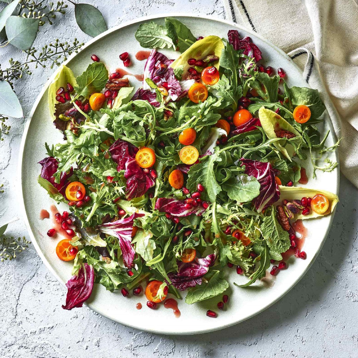 Winter Greens Salad with Pomegranate &amp; Kumquats Recipe | EatingWell